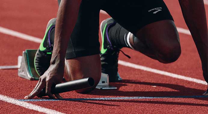 photo: baton in the hand of a track runner
